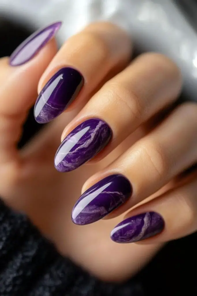 Cosmic swirl nails with shimmering purple.