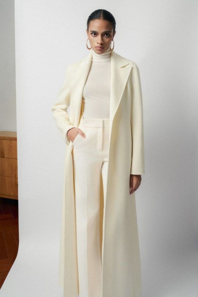 Ivory coat layered with tailored trousers