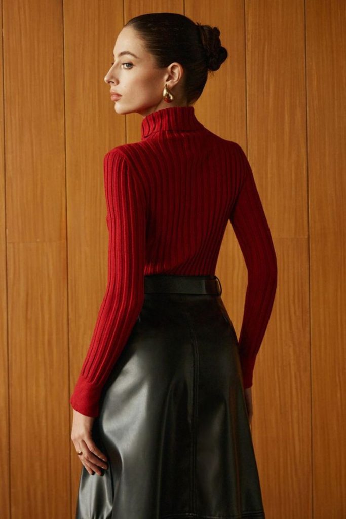 Scarlet knit sweater and black skirt