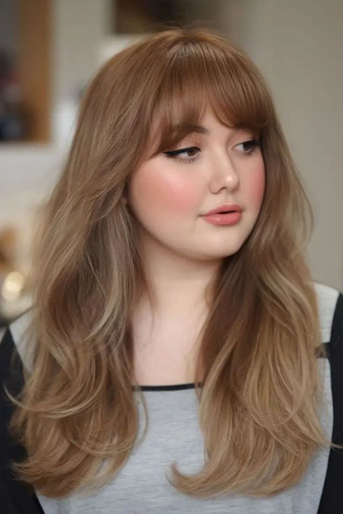 Voluminous blowout curtain bangs look