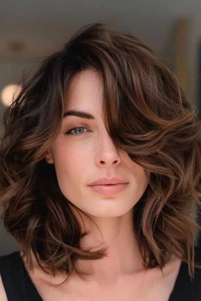 Wavy lob hairstyle with side-swept bangs