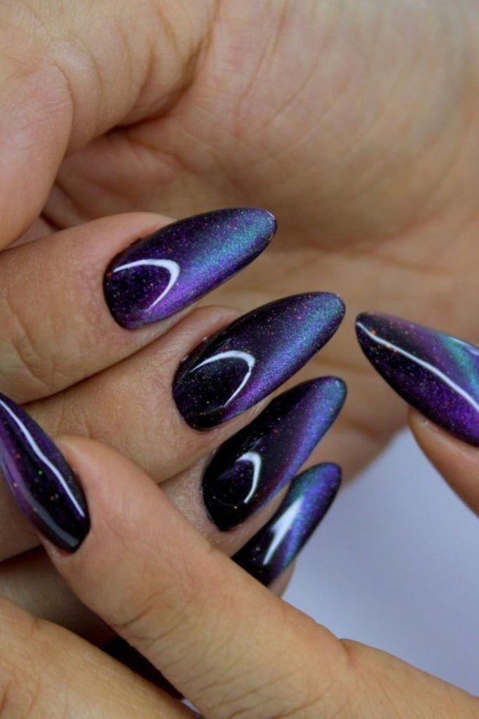 Black cat glowing feline eye nails.