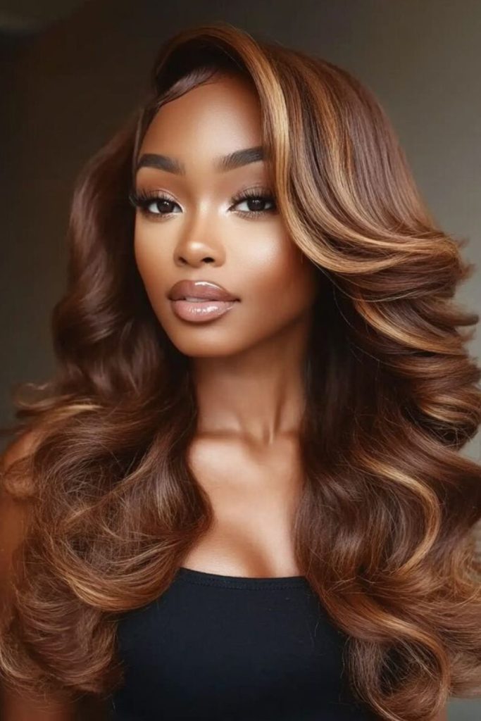 Caramel balayage waves with warm glow.