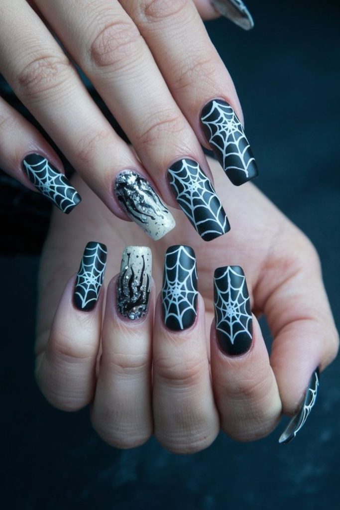 Cobweb chic silver spider web nails.