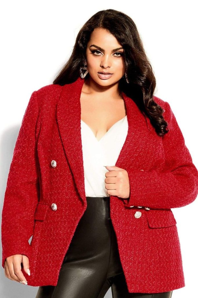 Red blazer dark jeans elegance.