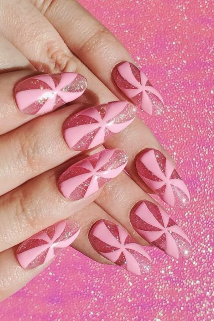 Peppermint swirl pink Christmas nails.