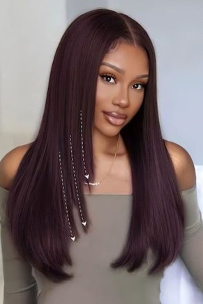 Rosewood straight hairstyle with warm hue.