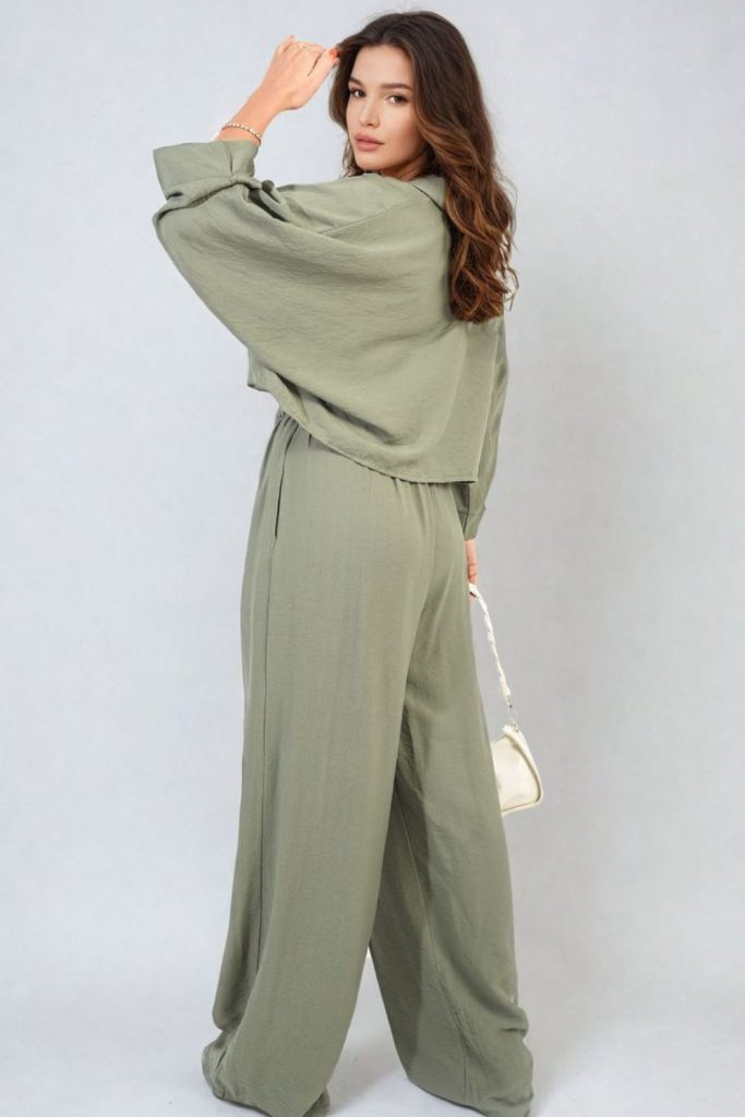 Sage co-ord blazer with gold jewelry.