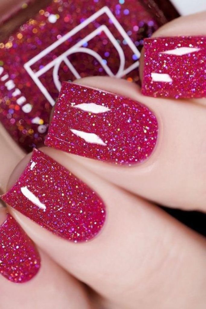 Glittery cranberry rose Christmas manicure.