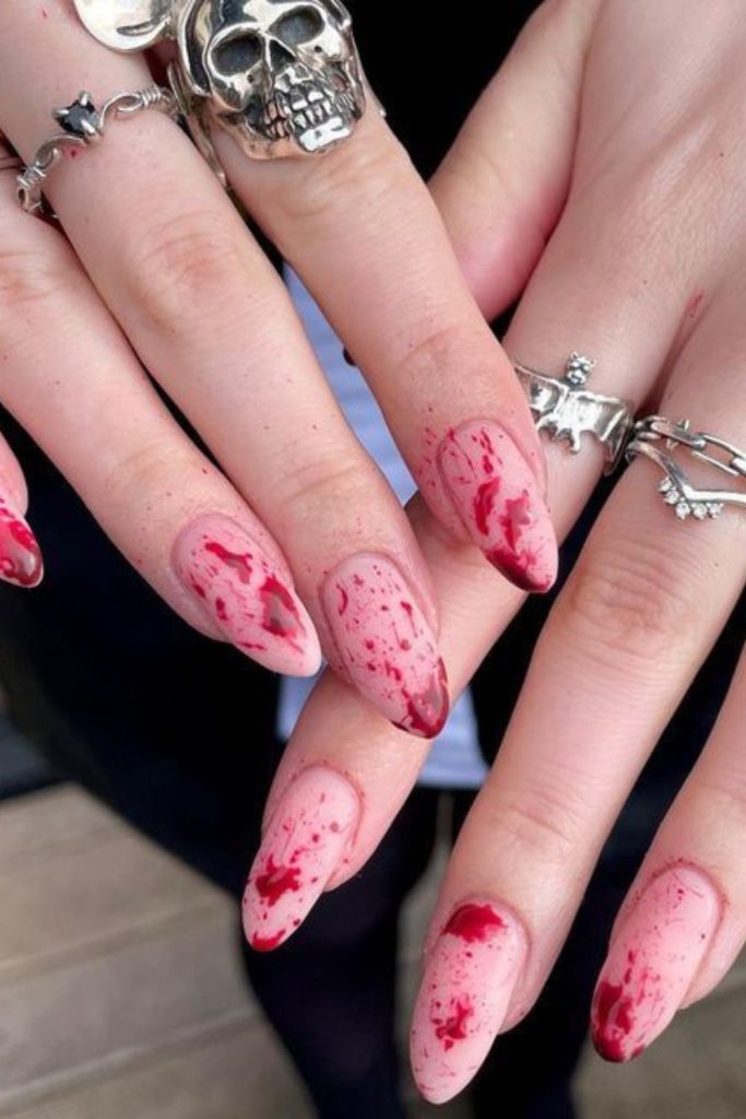 Spattered horror blood splatter nail design.