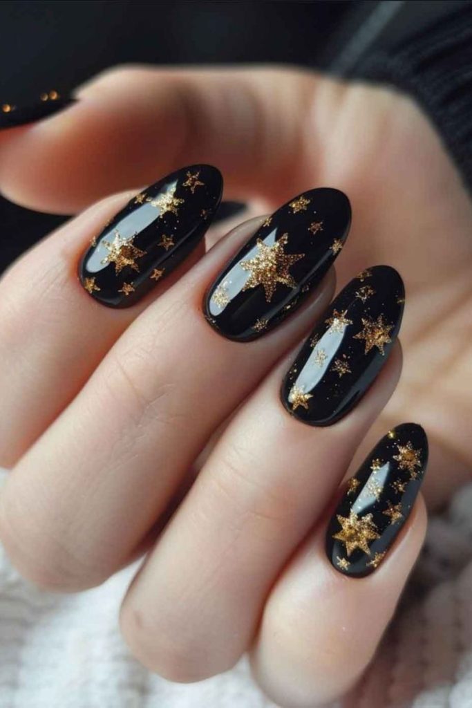 Starlit black gold garland nails.