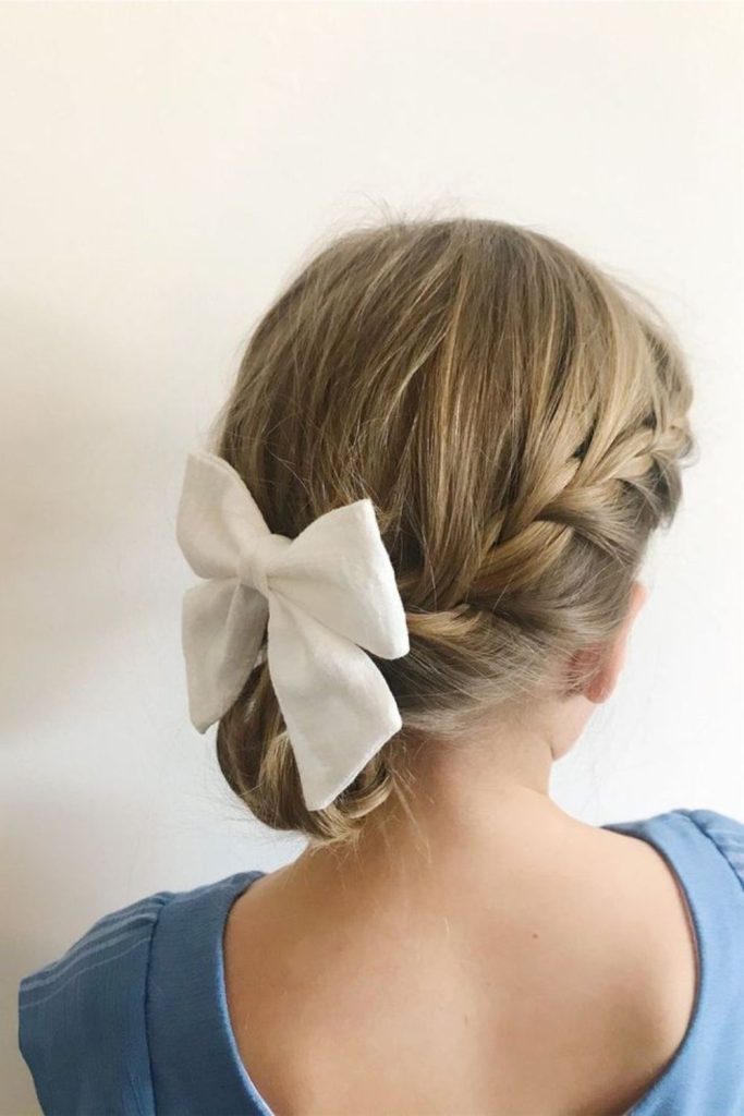 Twisted low bun with sparkly clip or bow.