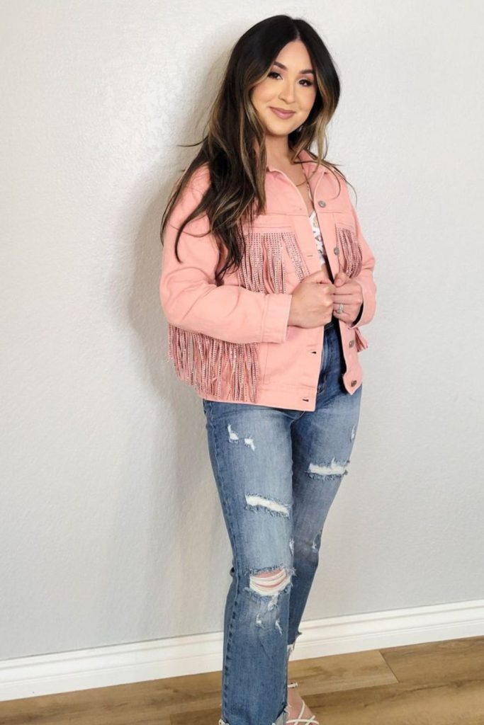 Pink suede jacket and faded jeans.