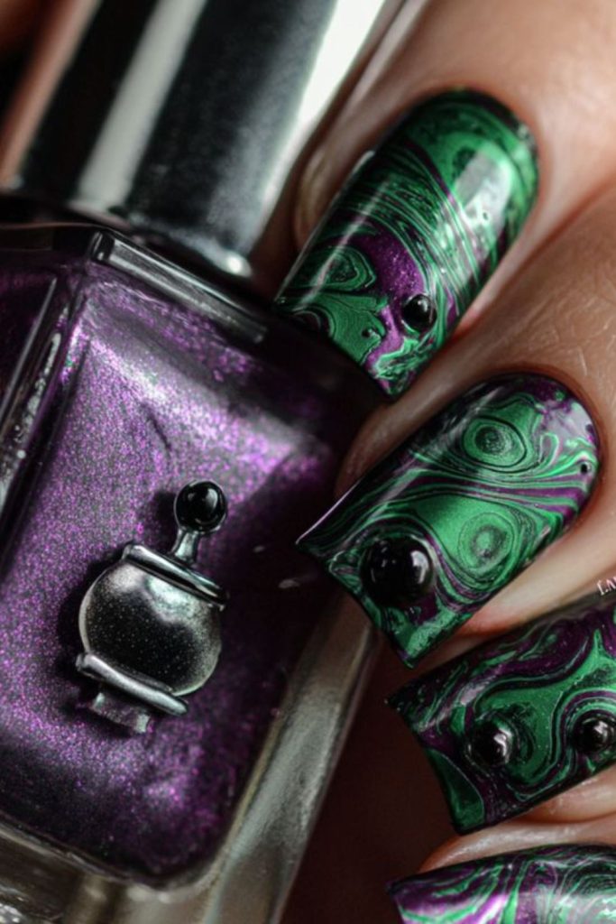 Witch’s brew purple green swirl nails.