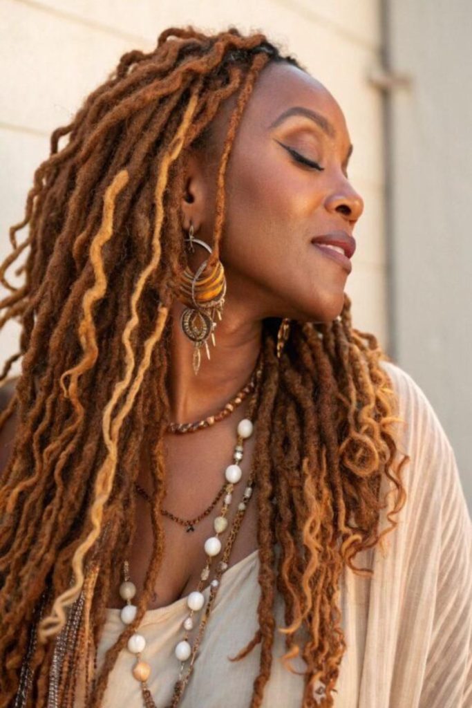 Warm copper locs glowing in sunlight