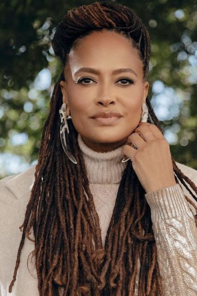 Warm bronze locs flickering in sunlight