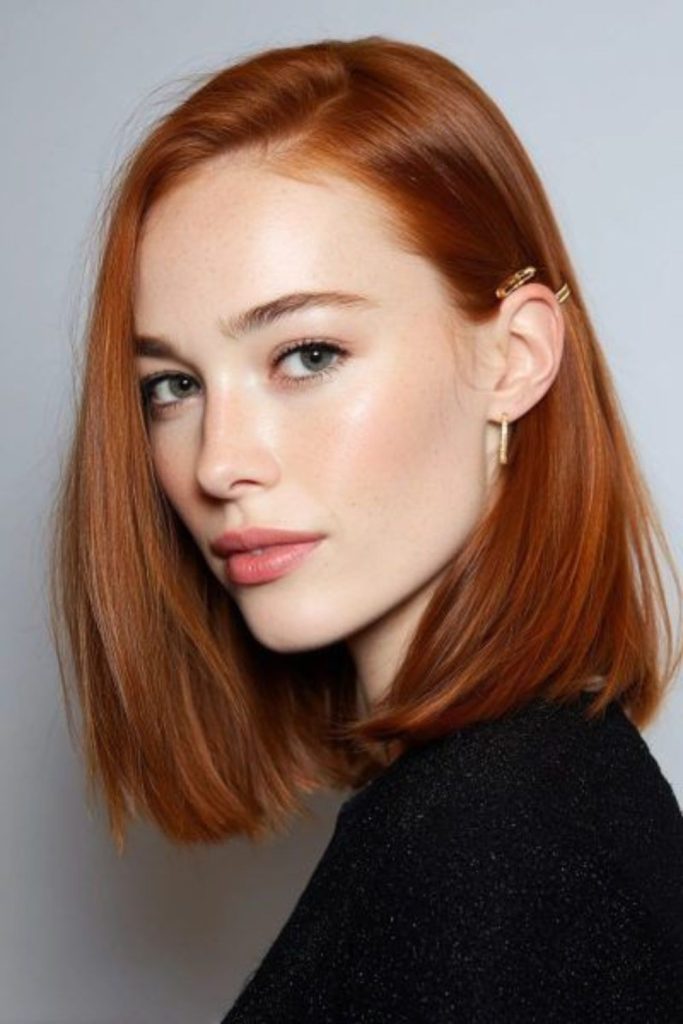 Shiny copper mid-length layered hairstyle.