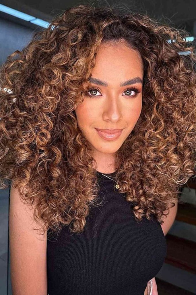 Soft caramel curls twisting voluminously