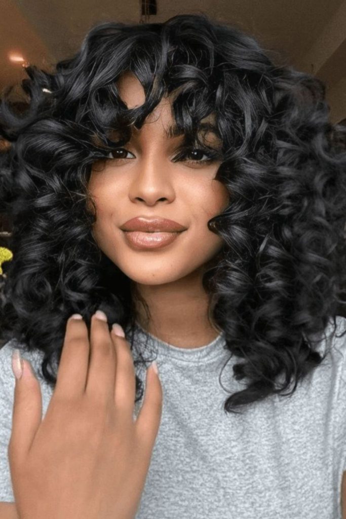 Dark halo curls framing face