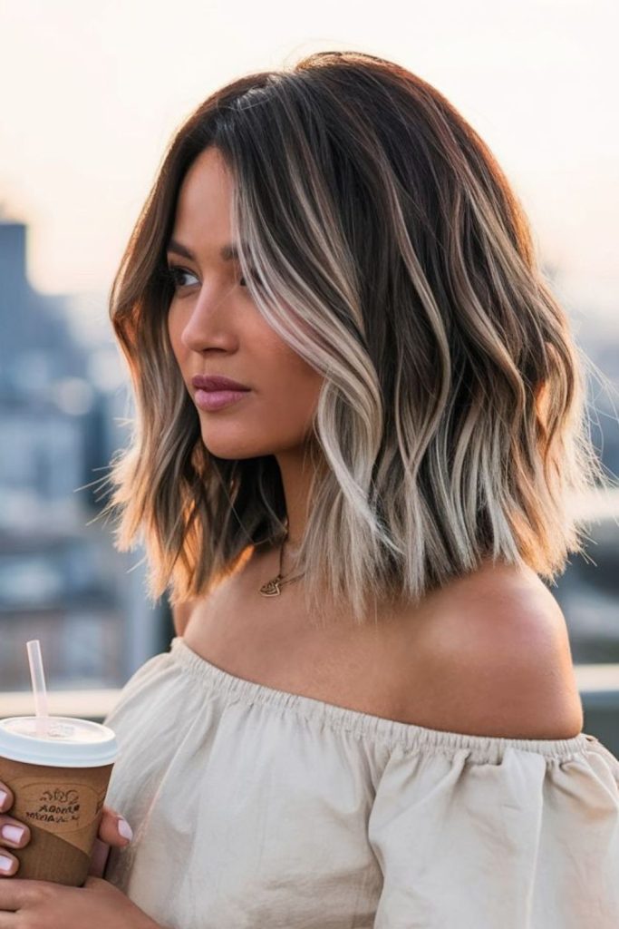 Dark roots fading into light tips.