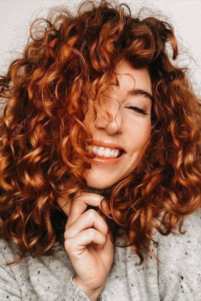 Tight corkscrew curls glowing warmly