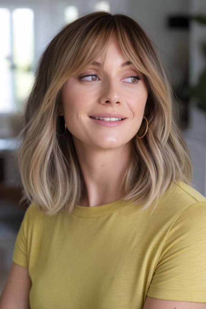Soft tousled center-parted wavy bob.