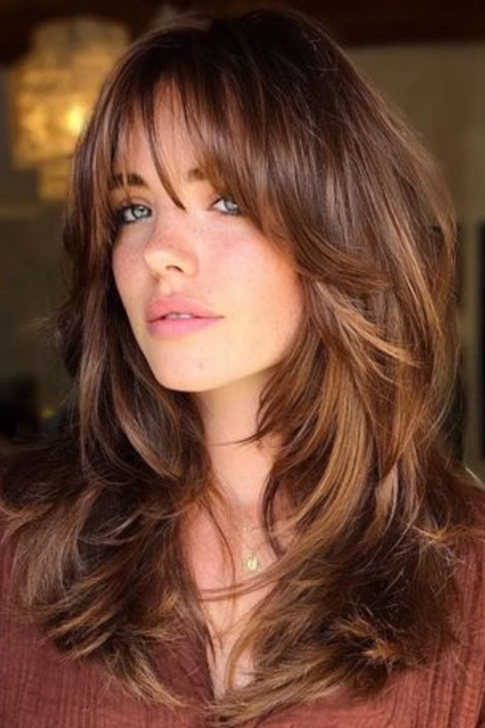 Flicked wisps create smoky hair effect.