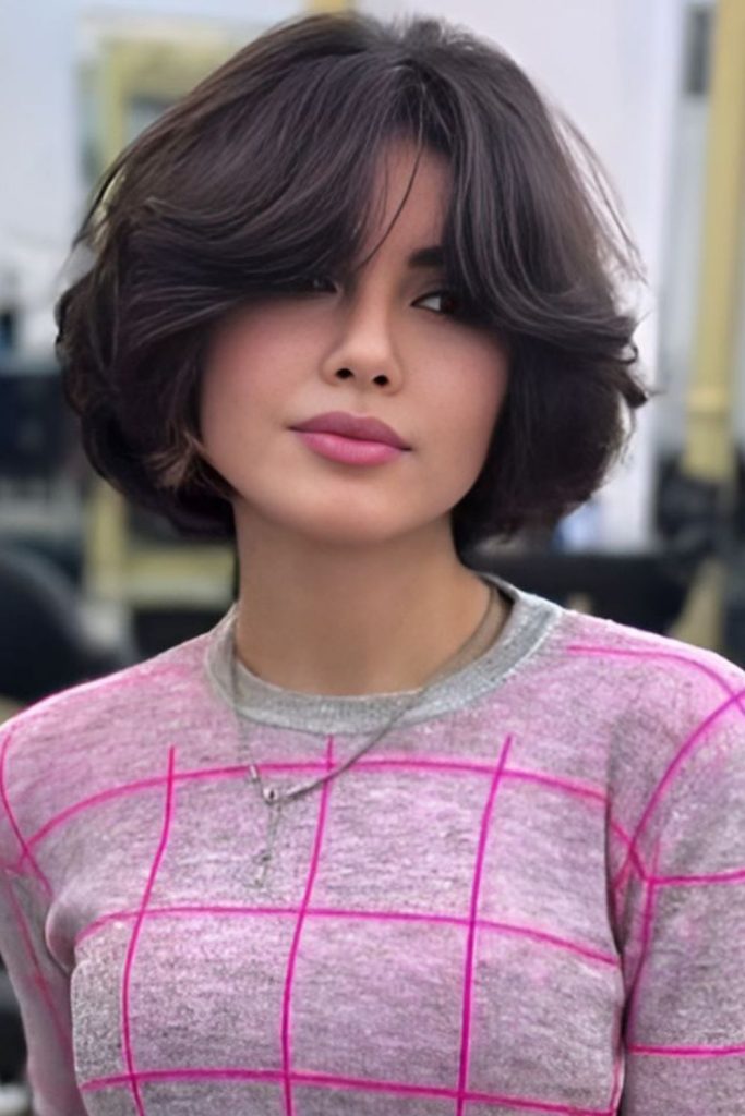 Wispy curtain pixie framing round cheeks