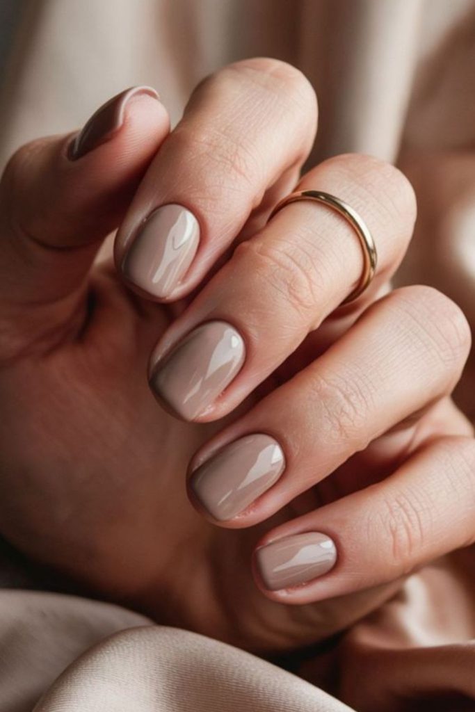 Biscotti beige short polished nails.