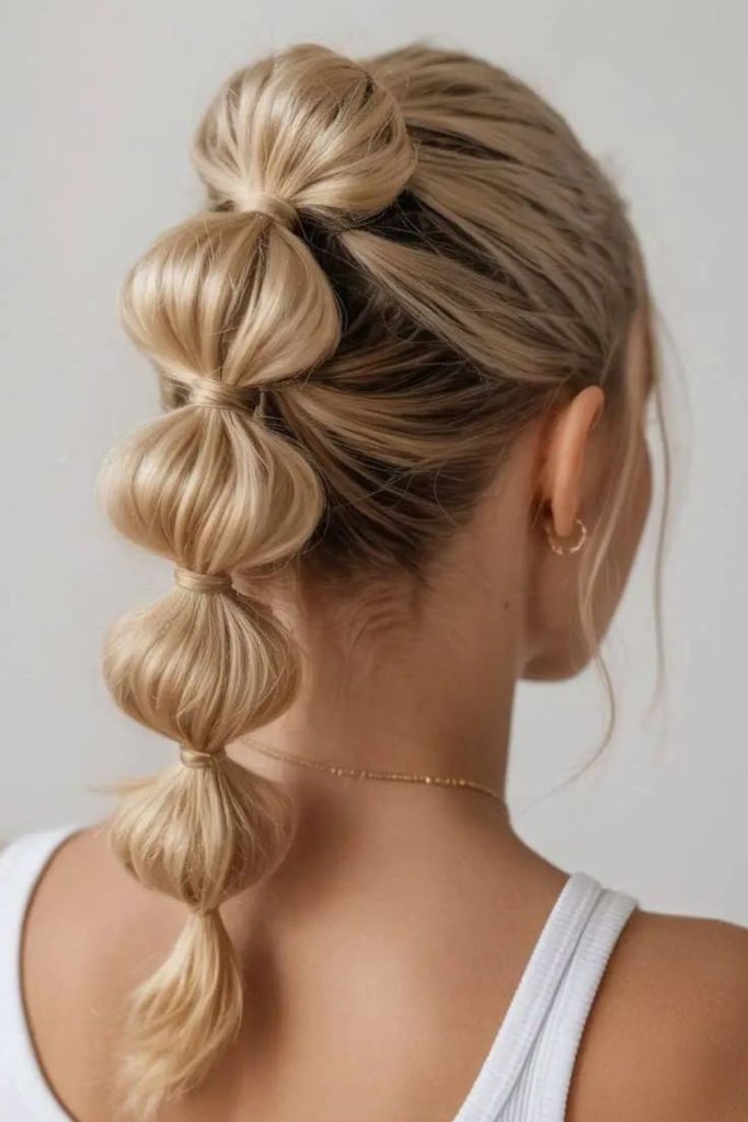 Playful sectioned ponytail with puffed spheres