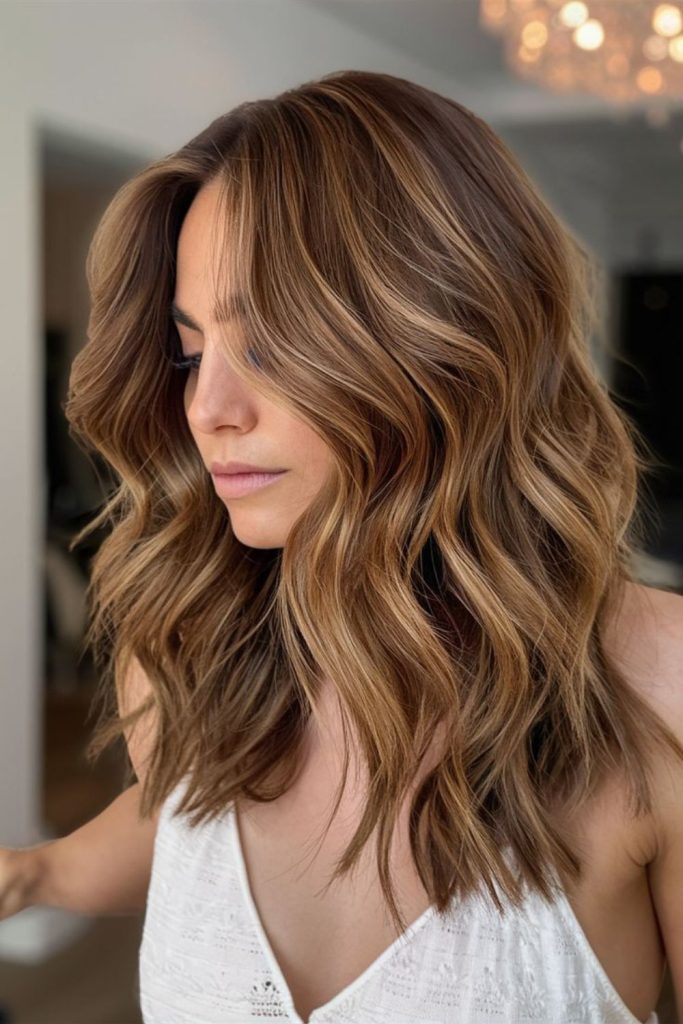 Layered balayage hair in golden tones.