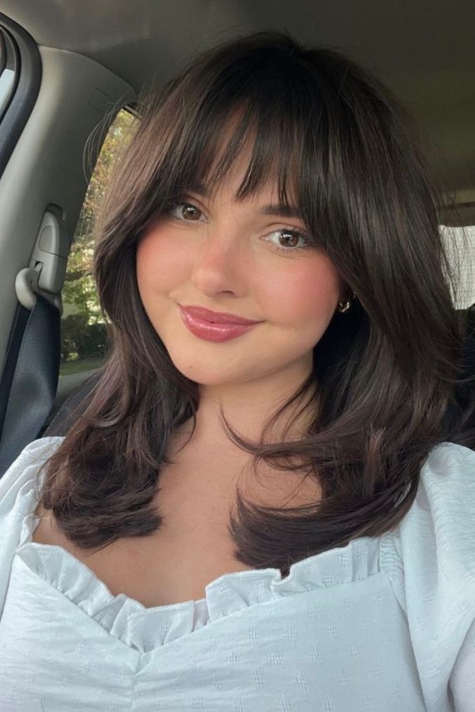 Soft French fringe complements round features