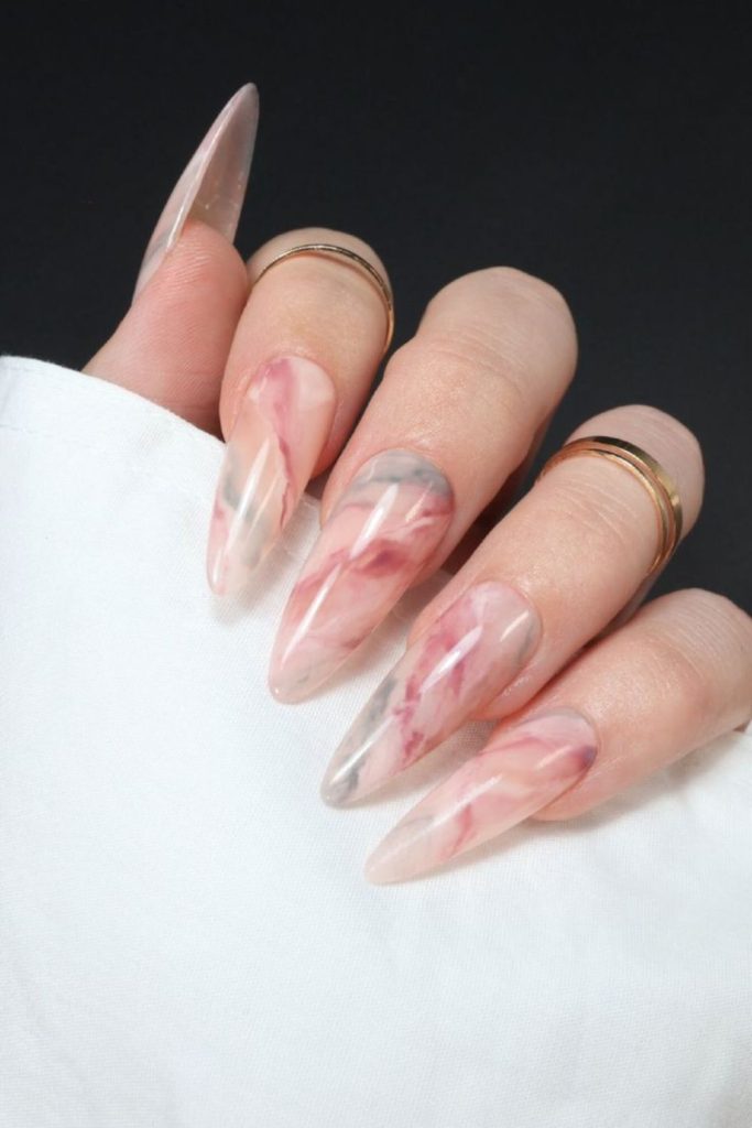 Soft stone-patterned nails with fluid swirls