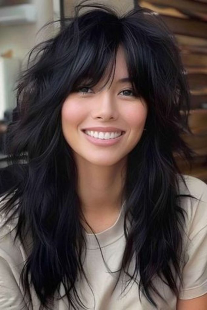 Dark layered wolf haircut with edgy flow