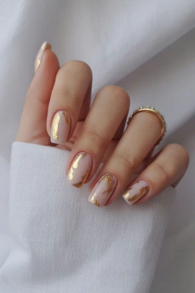 Neutral nails with thin gold detailing