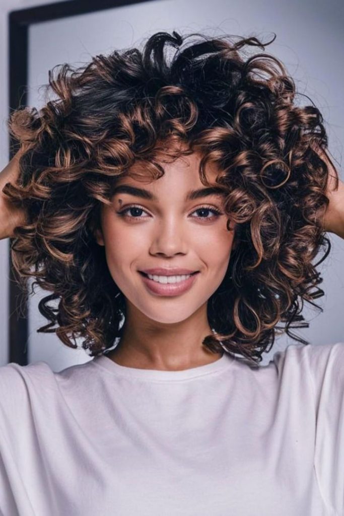 Jet black curls fall dramatically