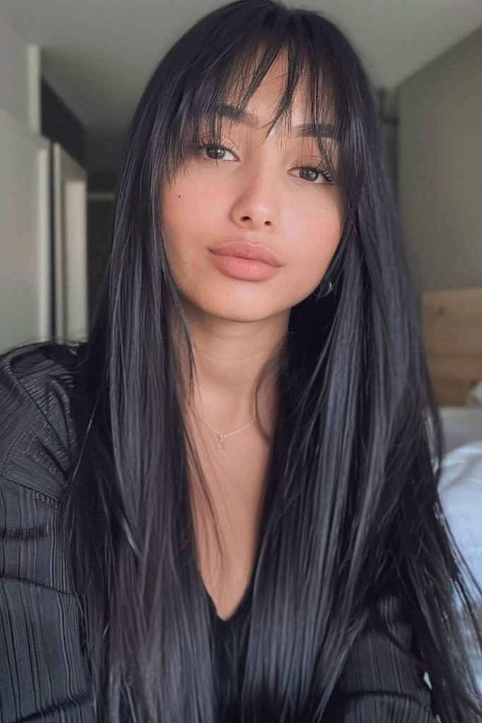 Commanding long straight black hairstyle.