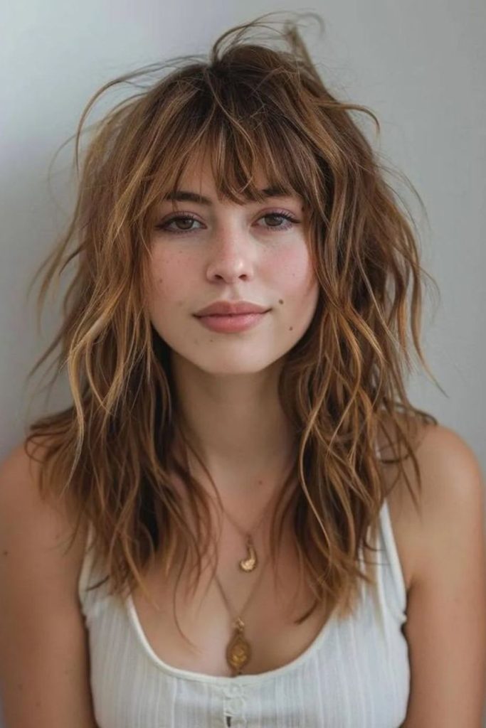 Sandy blonde flowing messy shag layers.