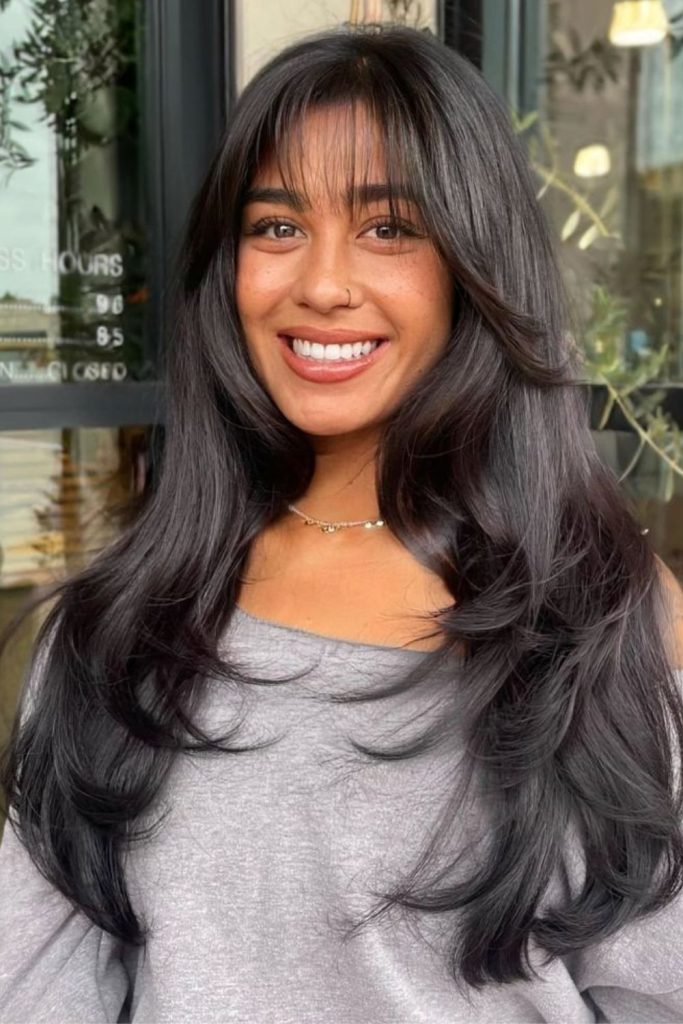 Subtle dark sleek straight hair.