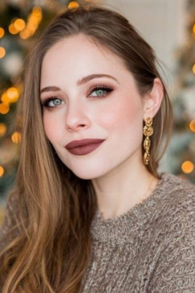 Sharp thin brows framing intense eyes