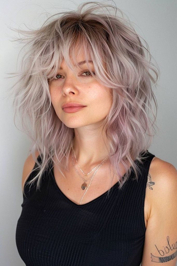 Dusky rose layered wolfcut with flair.