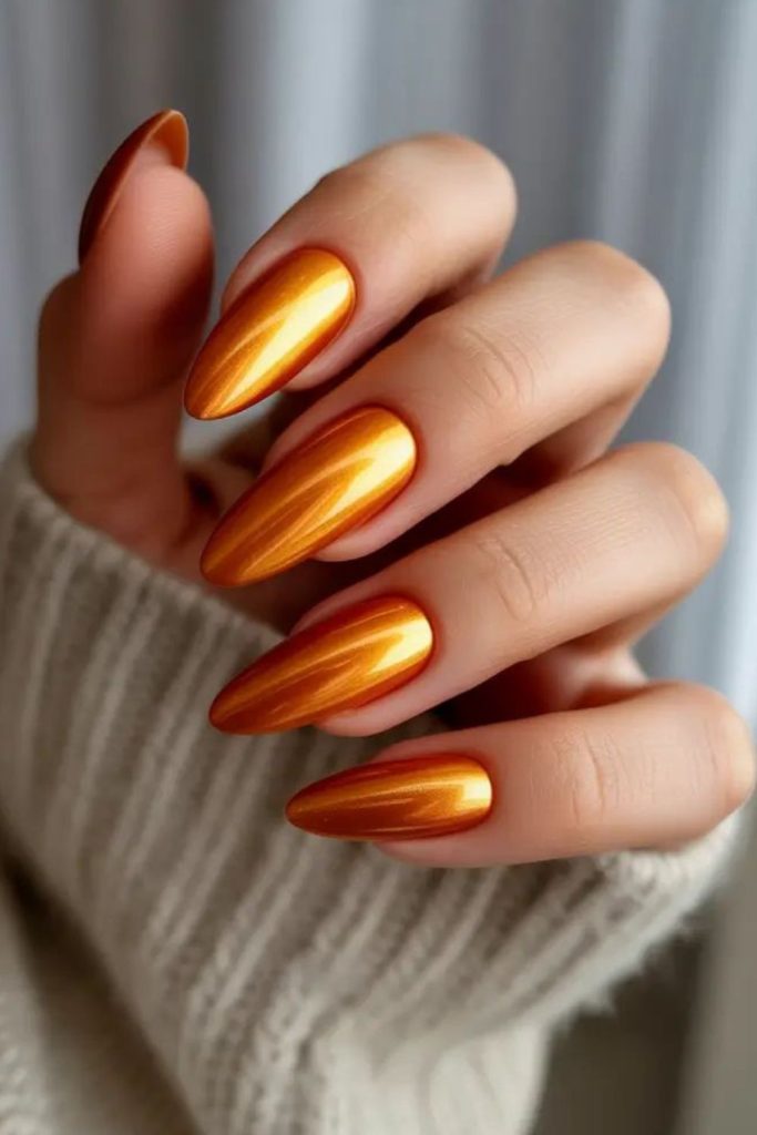 Warm amber nails with glitter shards.