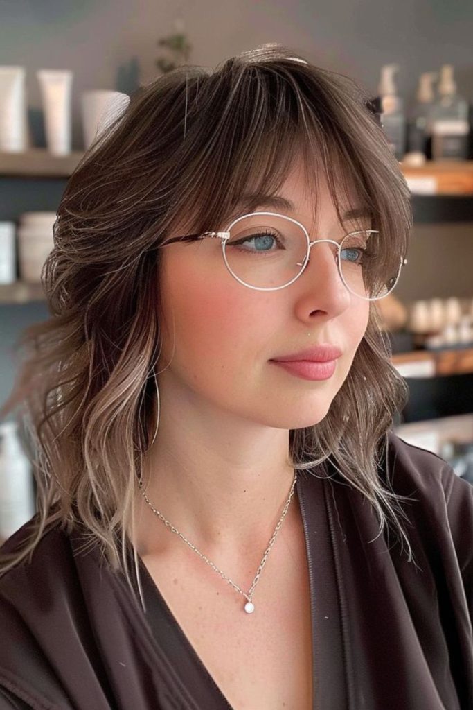 Asymmetric feather slice bangs creating softness