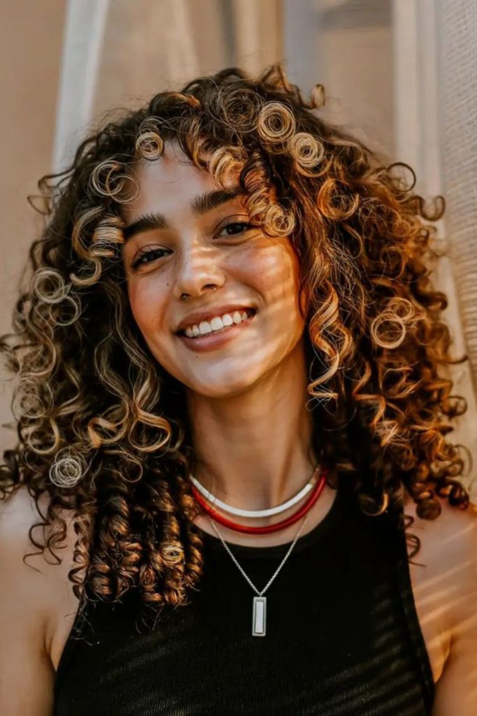 Rounded temple curls framing face elegantly.