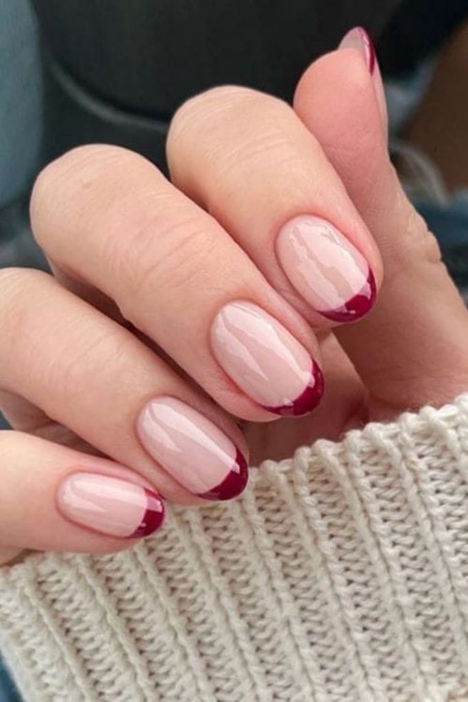 Raspberry tips over soft nude.