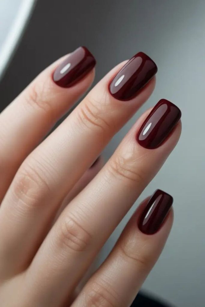 Matte burgundy stiletto nails with sparkle