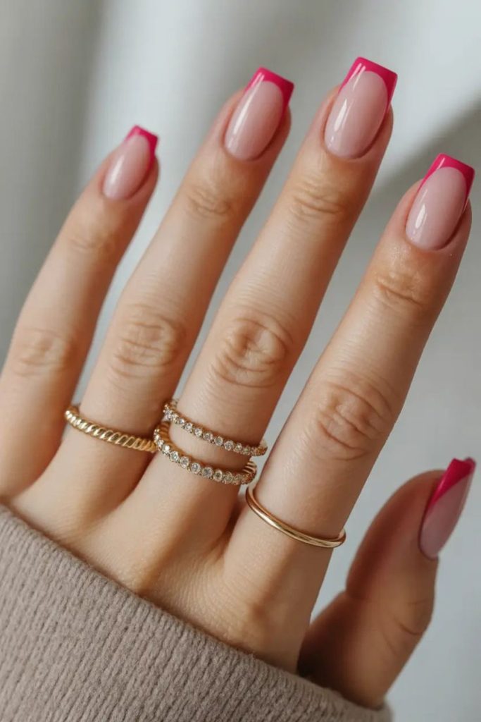 Pink tips on pale peach nails.