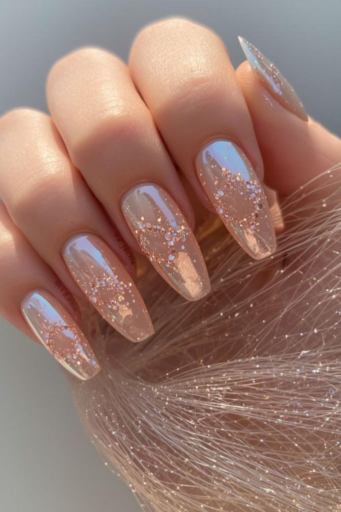 Peach nude nails with flowing gold foil.