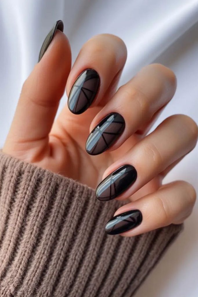 Grey streaks across deep black nails