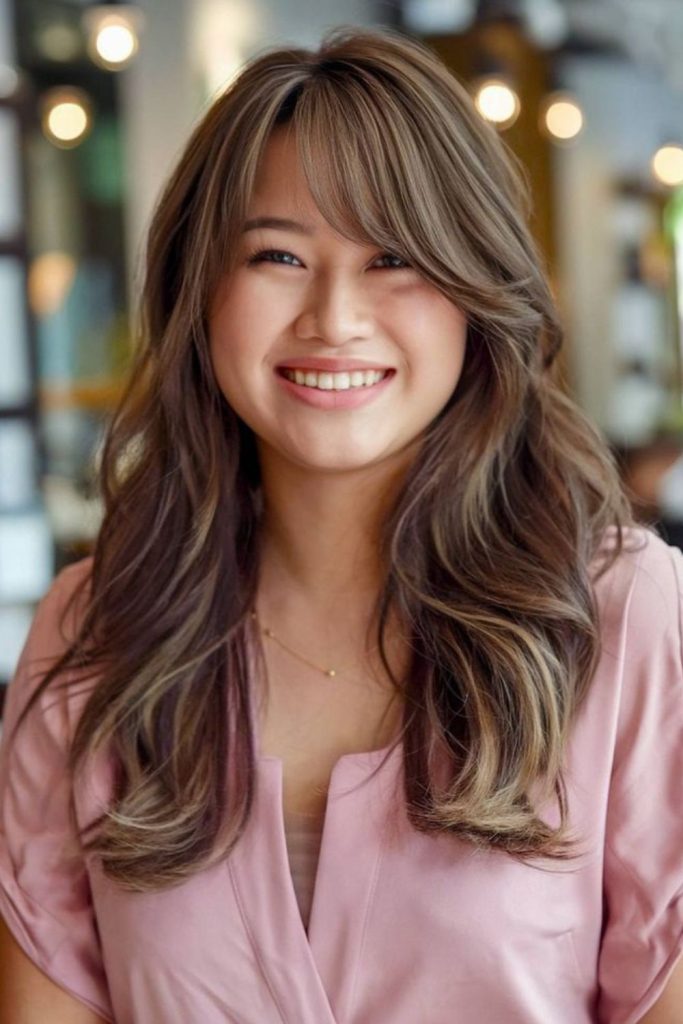 Side-draped layered bangs reducing face width